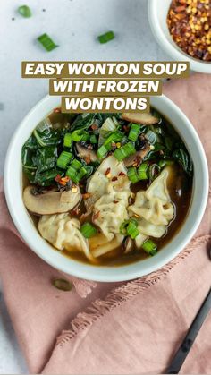 a bowl of wonton soup with green onions and spinach in it on top of a pink napkin