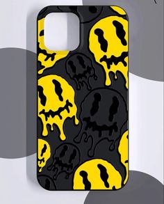 a cell phone case with yellow and black skulls on the front, against a gray background