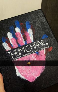 someone is holding up a box with handprints on the front and side of it