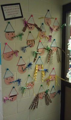 a bulletin board is decorated with native american masks and streamers for the classroom door