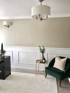 a living room with two green chairs and a white rug in front of the couch