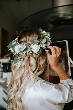 a woman with long blonde hair wearing a flower crown