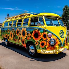 a yellow vw bus with sunflowers painted on it