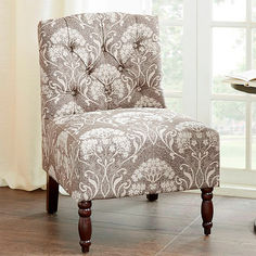 a brown and white chair sitting in front of a window