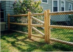 a wooden fence in front of a house