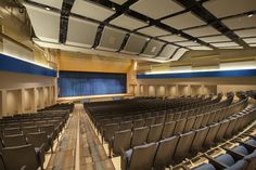 an empty auditorium with rows of seats facing the stage