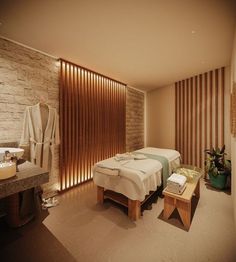 a couple of beds sitting in a room next to a sink and bathtub with wooden slats on the wall