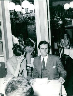 a man and woman sitting at a table in a restaurant