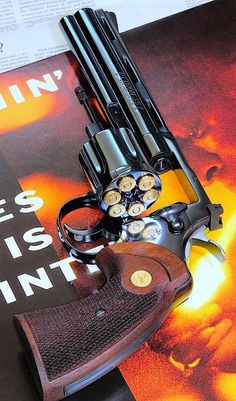 two revolvers are sitting on top of a book