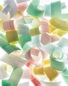 many different colored papers are arranged in the shape of hearts and numbers on a white background