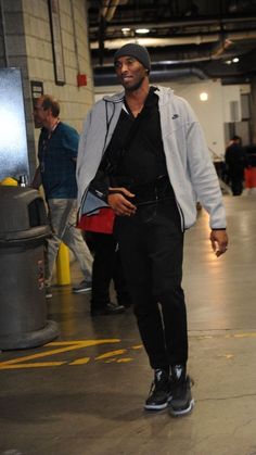 a man is walking through an airport terminal