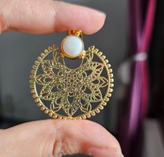 This is my masterpiece single design gold tone filigree pendant necklace with mother of pearl cabochon in between. This necklace is inspired from vintage era neckpieces. This metal work looks absolutely gorgeous on every age group. Item is made from pure brass and gold plated with 18k with guarantee of no corrosion of plating with regular use. D E T A I L S Diameter: 2" Disc pearl: 8mm Chain size: Adjustable from 12 to 18 inches Yellow Gold Medallion Jewelry As A Gift For Her, Gold Plated Round Medallion Necklace, Bohemian Gold Plated Jewelry With Intricate Design, Engraved Circular Jewelry Gift, Elegant Round Medallion Necklace Gift, Dainty Metal Jewelry With Pearl Pendant, Elegant Coin Pendant Jewelry As Gift, Pearl Pendant Medallion Jewelry As Gift, Coin Pendant Jewelry Gift For Her