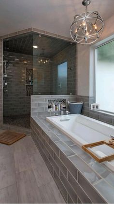 a bath room with a tub a sink and a large glass shower head mounted to the wall