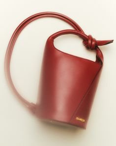 a red purse with a knot around it