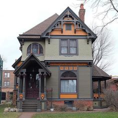 an old victorian style house with orange trim