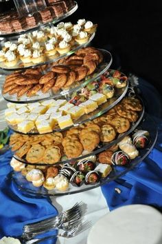 an assortment of desserts and pastries displayed on a platter at a wedding reception