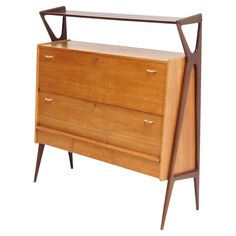 a wooden dresser with two drawers on one side and an iron bar on the other