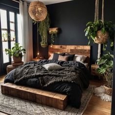 a large bed sitting on top of a wooden platform in a bedroom next to potted plants