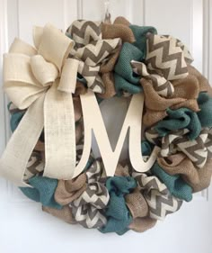 a wreath that has the letter m on it and is decorated with burlocks