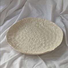 a white plate sitting on top of a bed