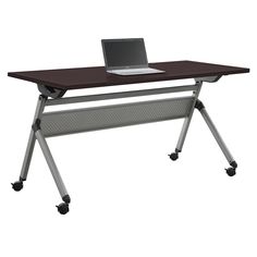 a laptop computer sitting on top of a wooden desk next to a metal rolling cart