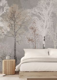 a bedroom with a bed, nightstand and wallpaper that has trees painted on it