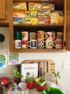 the kitchen counter is full of coffee cups and other items that are stacked on top of each other