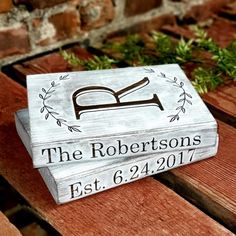 a wooden box sitting on top of a wooden bench with the name of the robertsons