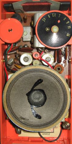 an orange box filled with lots of different types of electronic equipment and wires on top of each other