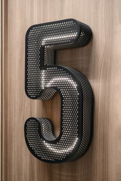 the letter s is made out of metal mesh