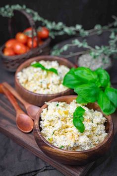 two wooden bowls filled with cottage cheese and basil