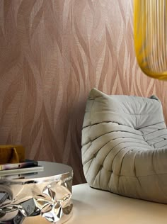 a living room with a chair, table and wall papered in woodgrain