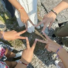 a group of people standing in a circle with their hands together