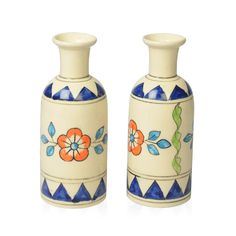 two vases with flowers painted on them sitting next to each other in front of a white background