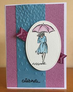 a handmade card with a woman holding an umbrella and the words celebrate written on it