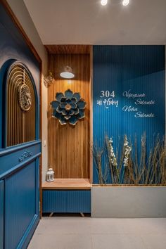 a blue and white entry way with flowers on the wall