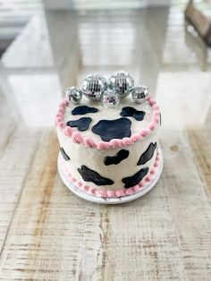 a decorated cake sitting on top of a wooden table