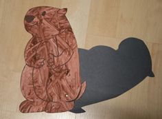 a paper cut out of a groundhog on top of a wooden floor