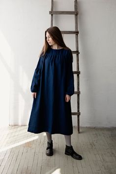 "Victorian dress is made from 100% soft and washed linen.  Details: - Colour: Navy blue - Composition: 100% Oeko-Tex certified linen - Peach ribbon in the back - Ruffled long sleeves - Pockets - Belt included - Medium weight linen - Linen care: machine wash gentle; tumble dry low, ironing optional - The price is for one dress, other pictured items are not included The model is 173 cm/5'8\" and wears a size S." Navy Blue Victorian Dress, Dark Blue Victorian Dress, Vintage Blue Victorian Dress For Spring, Blue Victorian Dress, Blue Victorian Dress With Lace Trim, Blue Long Sleeve Vintage Prairie Dress, Peach Ribbon, Victorian Fashion Dresses, Maxi Dress Long Sleeve