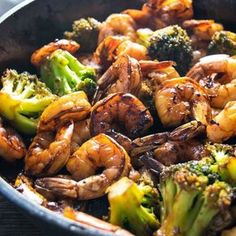 a skillet filled with broccoli and shrimp