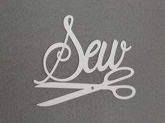 the word sew is cut in white paper