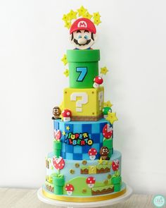 a birthday cake made to look like mario's tower with the number seven on top