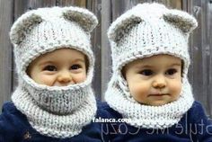 two babies wearing knitted hats and scarves, one with a bear's head on it