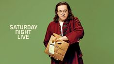 a man with glasses holding a brown bag in front of a green background that says saturday night live