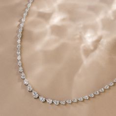 Turn heads with this mesmerizing piece, flaunting an impressive 10.00 total carats of graduating east-west pear-shaped diamonds. Let this exquisite piece represent your exceptional taste and style; it's sure to be the center of admiration wherever you go. Diamonds Direct, Jewellery Photography Inspiration, Diamond Tennis Necklace, Cvd Diamond, East West, Tennis Necklace, Jewelry Photography, Pear Shaped Diamond, Pear Shaped