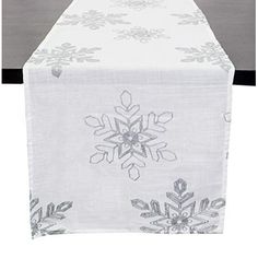 a white table runner with snowflakes on it