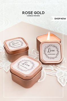 two candles sitting next to each other on top of a lace doily covered table