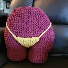 a crocheted stuffed animal sitting on top of a couch