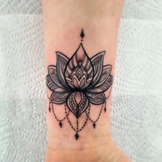 a lotus flower tattoo on the ankle