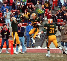 the football players are celebrating their team's victory over the crowd at the game